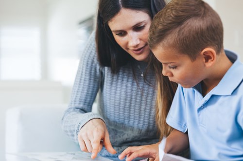 a home tutor teaching a young boy