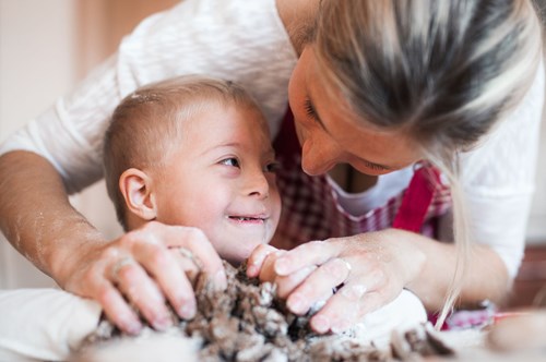 a mother playing with her child with additional needs