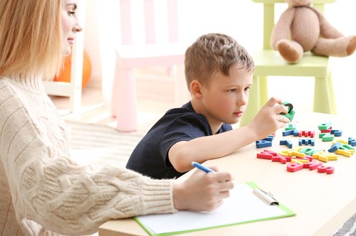 An autistic child participating in a learning exercise