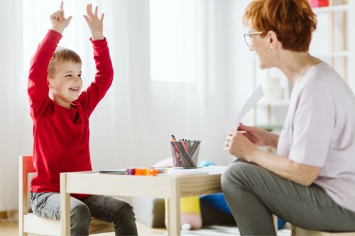 an adult conducting a drawing activity with a child