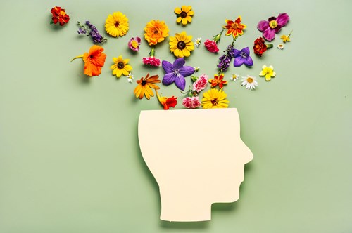 flowers pouring from the top of a paper head