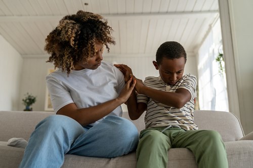 a child being angry next to his mother