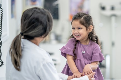 a doctor talking to a young girl