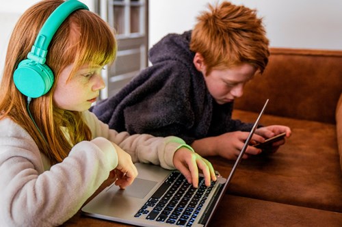 two children using devices